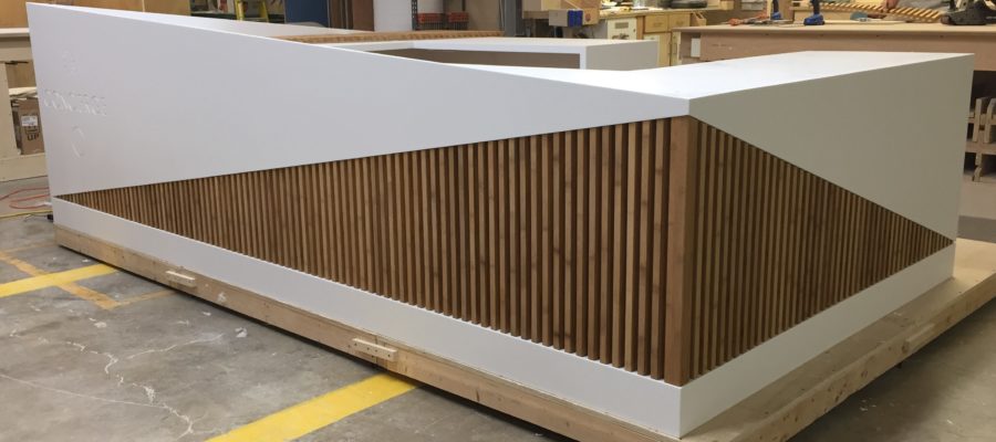 Information desk built with a combination of solid surface and bamboo materials